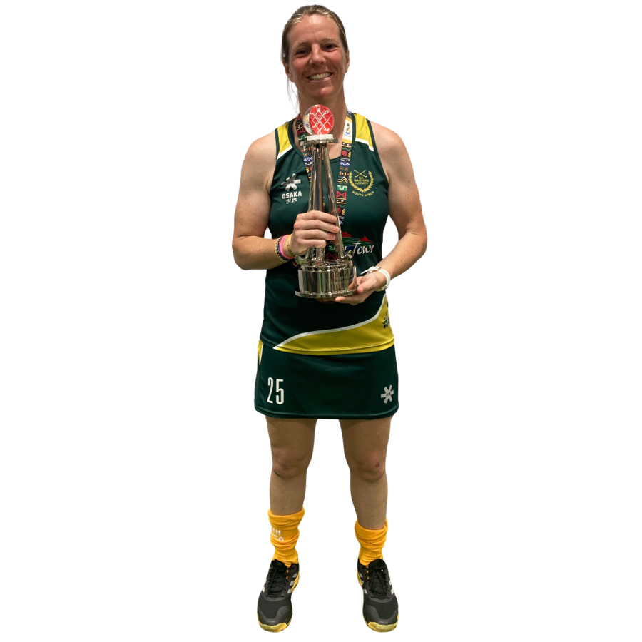 Lauren Penny in her South Africa kit, holding the Masters World Cup trophy